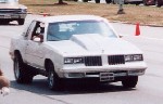 Souped up white Cutlass.